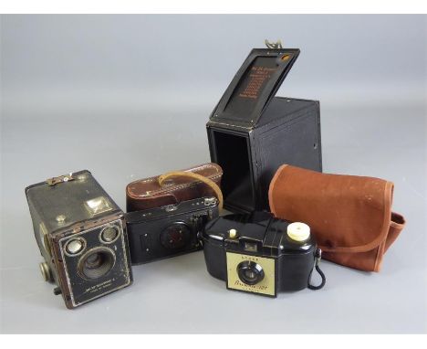 Four Vintage Cameras. The cameras including a 'Vest Pocket Kodak', in the original leather case, a Kodak Brownie 127 Camera i