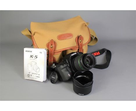 A Pentax SLR Digital Camera. Model No K-5, including 49 mm and 52 mm lenses, two camera hoods, complete with operating manual