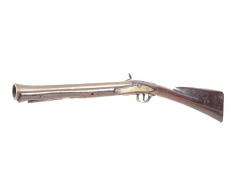 AN EARLY 19TH CENTURY KETLAND BLUNDERBUSS with percussion action, the walnut stock with brass mounts and strawberry finial en