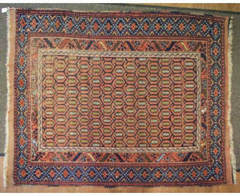 An antique Afshar wool rug. With a 'Paisley' influenced ground of brown/red is surrounded by a similar coloured primary borde