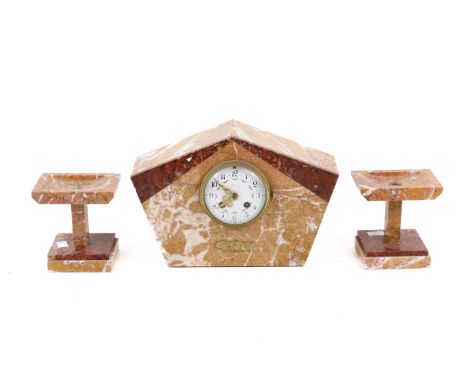 A marble mantle clock and garnitures. An enamel face, striking on a bell, H21cm.