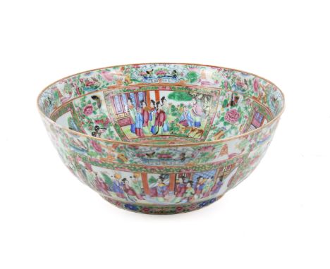 A large late 19th century Chinese Canton enamel famille rose punch bowl. Decorated to the inside walls with four panels of fi