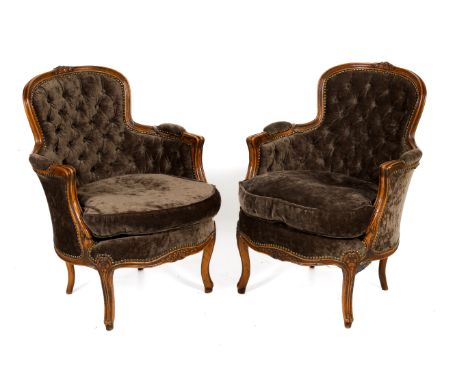A pair of button back armchairs. With fluted details to frame, grey velvet upholstery with separate seat cushions and brass s
