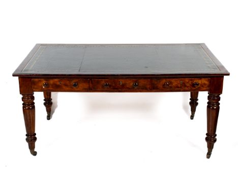An early 20th century mahogany rectangular library writing table. Top inset with a panel of tooled green leather, three friez
