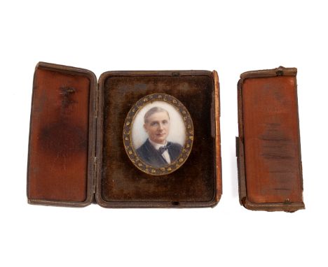 An early 20th Century portrait miniature on ivory of a gentleman. With hair slicked to the side and wearing a bow tie, 5.3cm 