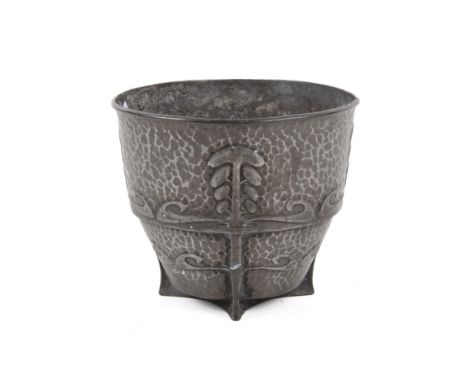 An early 20th century Tudric pewter vessel. With a hammered surface, decorated with four tree-like reliefs running down to th