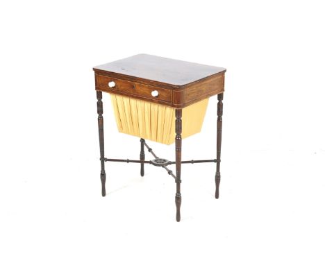 An early 19th century inlaid rosewood work table. The fitted drawer with ivory handles and opening to reveal a compartmentali
