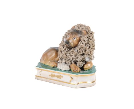 A 19th century Staffordshire lion and lamb figurine by John & Rebecca Lloyd. Circa 1850, the  lion is raised on a rounded rec