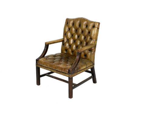 A circa 1900 leather button back armchair. Green leather upholstery with stud detail to square legs with three stretchers. H1