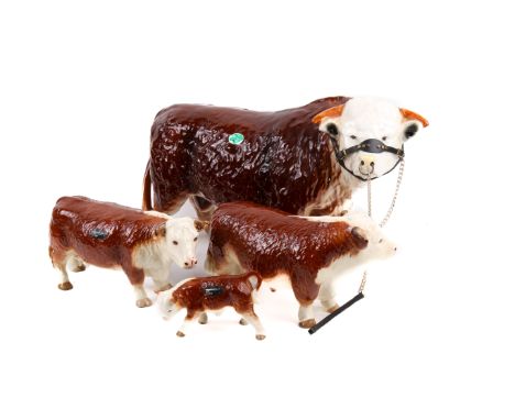 A collection of ceramic Hereford cows. Including A large Neilson Bull and three coopercraft cows, max H26cm. 