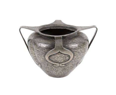 An early 20th century Liberty & Co pewter four handled 'Tudric' vase. The body with a hammered stippled surface, two pairs of