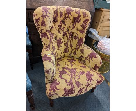 A Victorian style button back armchair 