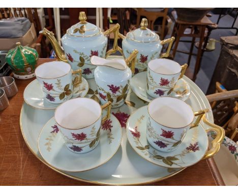 A Limoges teaset for four consisting of teapot, sugar bowl, milk jug, tray, cups and saucers 