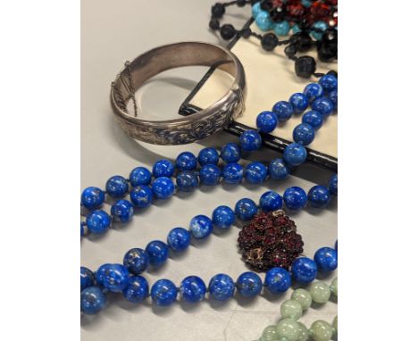 A group of costume jewellery to include lapis necklace and others, silver bangle, gold plated rings, brooch and others, house