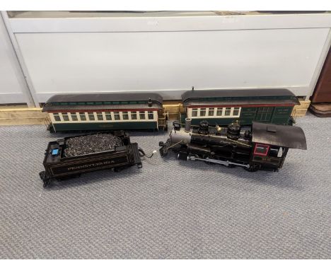 A large gauge Bachmann plastic model railway to include locomotive tender, two carriages, track and accessories 
