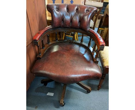 A reproduction mahogany button back swivel office chair 
