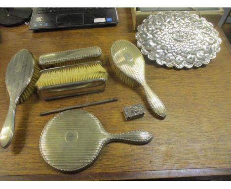 A selection of silver clad dressing table brushes, a comb (without teeth), and a hand mirror (mixed dates and makers), along 