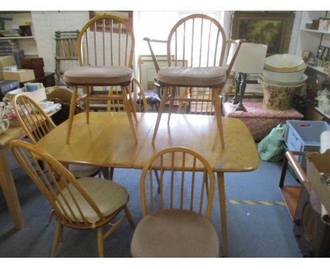 An Ercol Windsor extending blonde plank dining table with two extra leaves, along with four Quaker dining chairs and three Wi