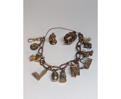 A 9ct gold curb link charm bracelet having eleven various charms to include The Palace of Westminster, St Christopher and oth