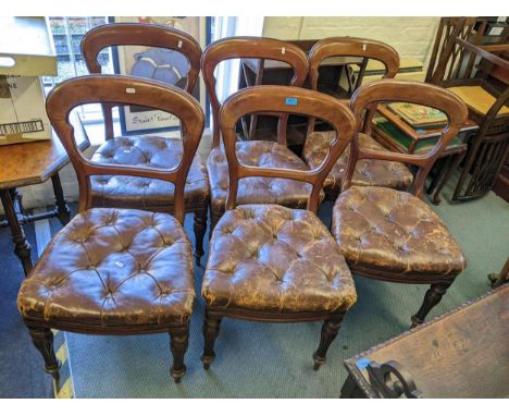 A set of six Victorian mahogany bar back dining chairs with leather button upholstered seats on carved turned legs Location: 