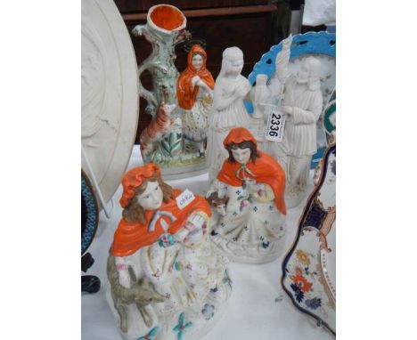 Four early 20th century Staffordshire and bisque figures.