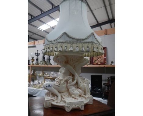 A figural table lamp with shade.