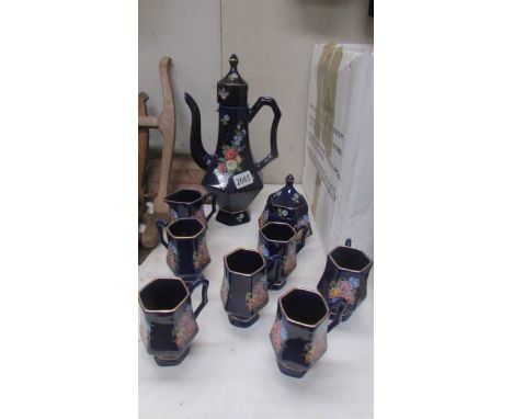 A hand painted blue ceramic coffee set.