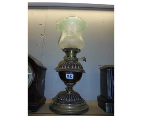 A brass oil lamp with later etched glass shade. COLLECT ONLY.