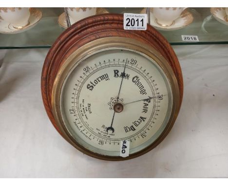 A cased ship's barometer.