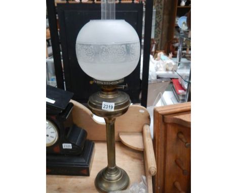 A brass oil lamp complete with shade, COLLECT ONLY.