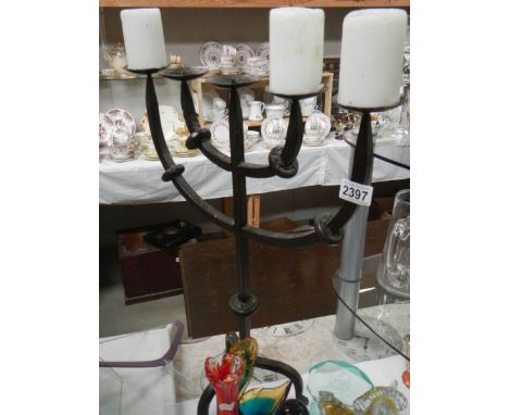 A 20th century forged metal candlestick.