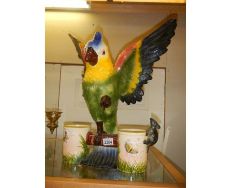 A large ceramic parrot with two feeding bowls. COLLECT ONLY.