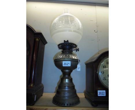 A brass oil lamp with later etched glass shade. COLLECT ONLY.