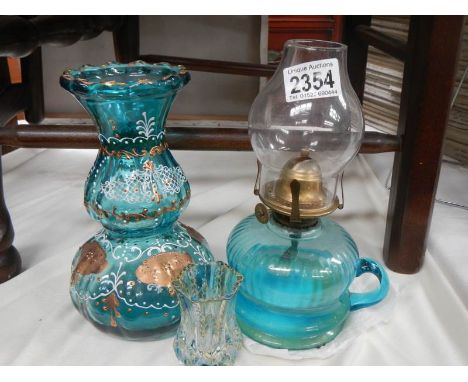 A Victorian blue glass hand oil lamp.