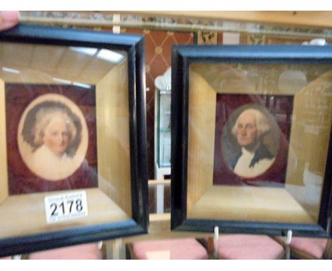 A pair of framed and glazed print portraits of George Washington and Martha Washington.