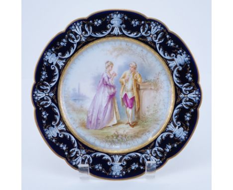 19/20th Century Sevres Portrait Plate. Painted with a romantic courting scene. Gold and pate-sur-pate decorated cobalt border