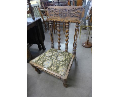 A Celtic style carved mahogany armorial chair 