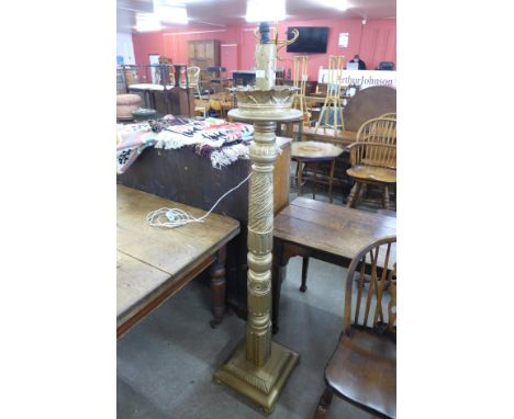 A carved giltwood standard lamp 