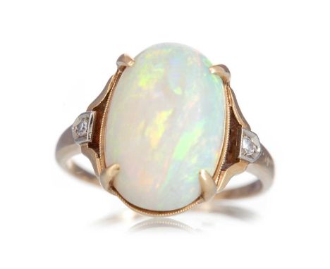 OPAL AND DIAMOND RING set with a cabochon opal flanked by small diamonds, marked 14K, size N 1/2Qty: 4.1g