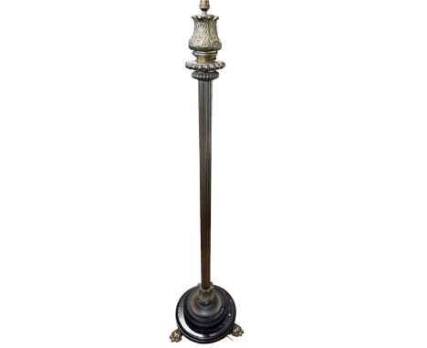 Brass reeded column standard lamp on three paw feet.