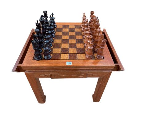 Oriental rosewood chess table having two slides and two storage drawers together with a carved wood chess set complete, table