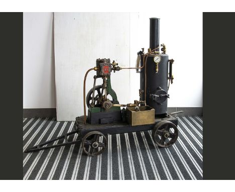 A Stuart Turner Single-cylinder Vertical Engine on 4-wheeled trolley, the engine itself standing 14" high with a 7" diameter 