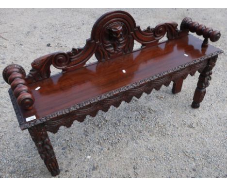Carved oak hall bench/window seat with elaborate carved detail and turned arm supports (121cm x 30cm x 75cm) 