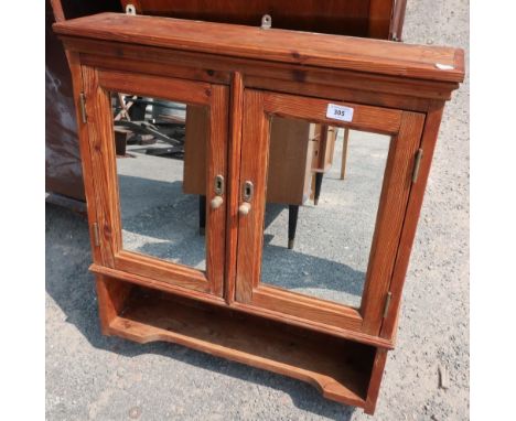 Waxed pine wall cupboard enclosed by two mirror panelled doors, above open shelf (64cm x 16cm x 72cm) 