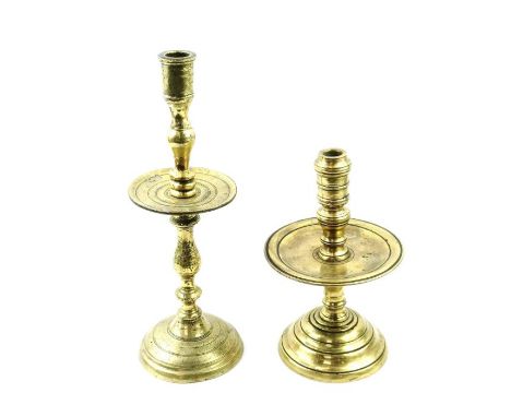 An 18th century brass heemskerk candlestick, 24cm high, along with a 19th century example, 34cm high