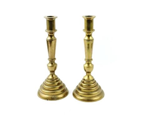 A pair of brass cast candlestick, each standing on stepped base, 26cm high 