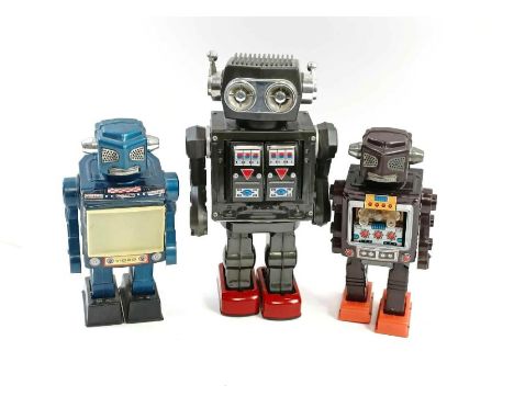 Vintage toys - A battery operated tin plate robot, along with two plastic examples, all stamped "Made in Japan"