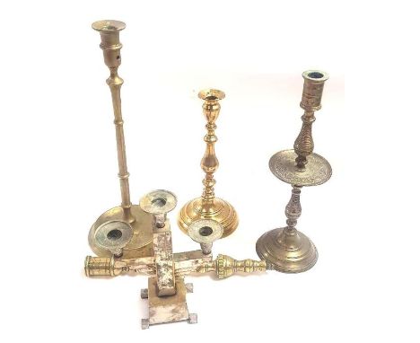 A collection of candlesticks to include a heemskerk candlestick, an Art Deco chrome candlestick, two brass candlesticks and o