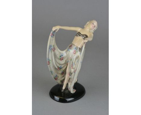 A GOLDSCHEIDER STEPHAN DAKON ART DECO FIGURE MODELLED AS A LADY, posed with outstretched arms holding up her floral skirt, on