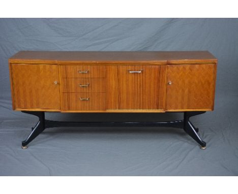 A STONEHILL GIO PONTI STYLE TEAK AND ROSEWOOD FINISH BREAKFRONT SIDEBOARD, flanked by three graduated drawers and fall front 